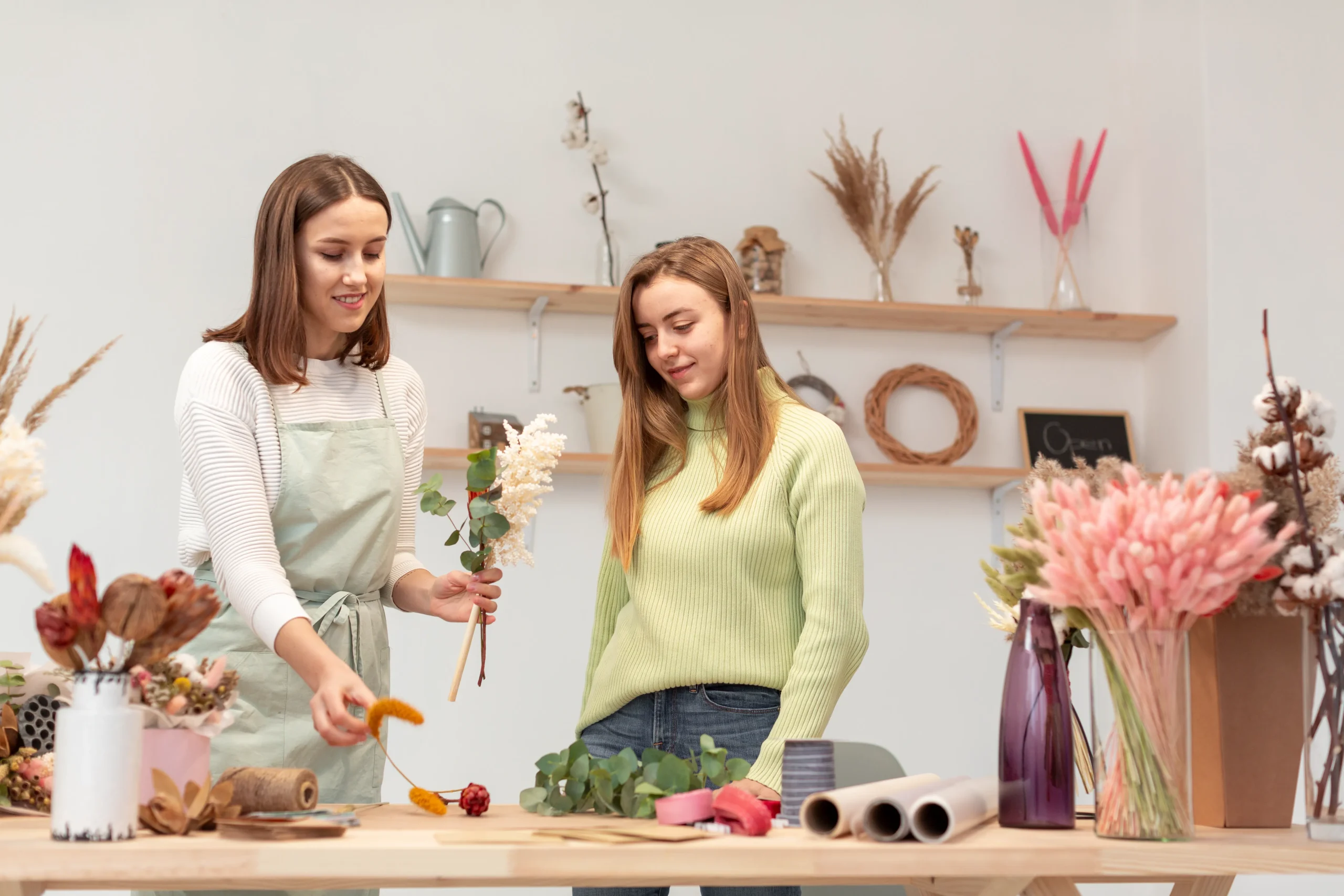 Women arranging flower bouquets