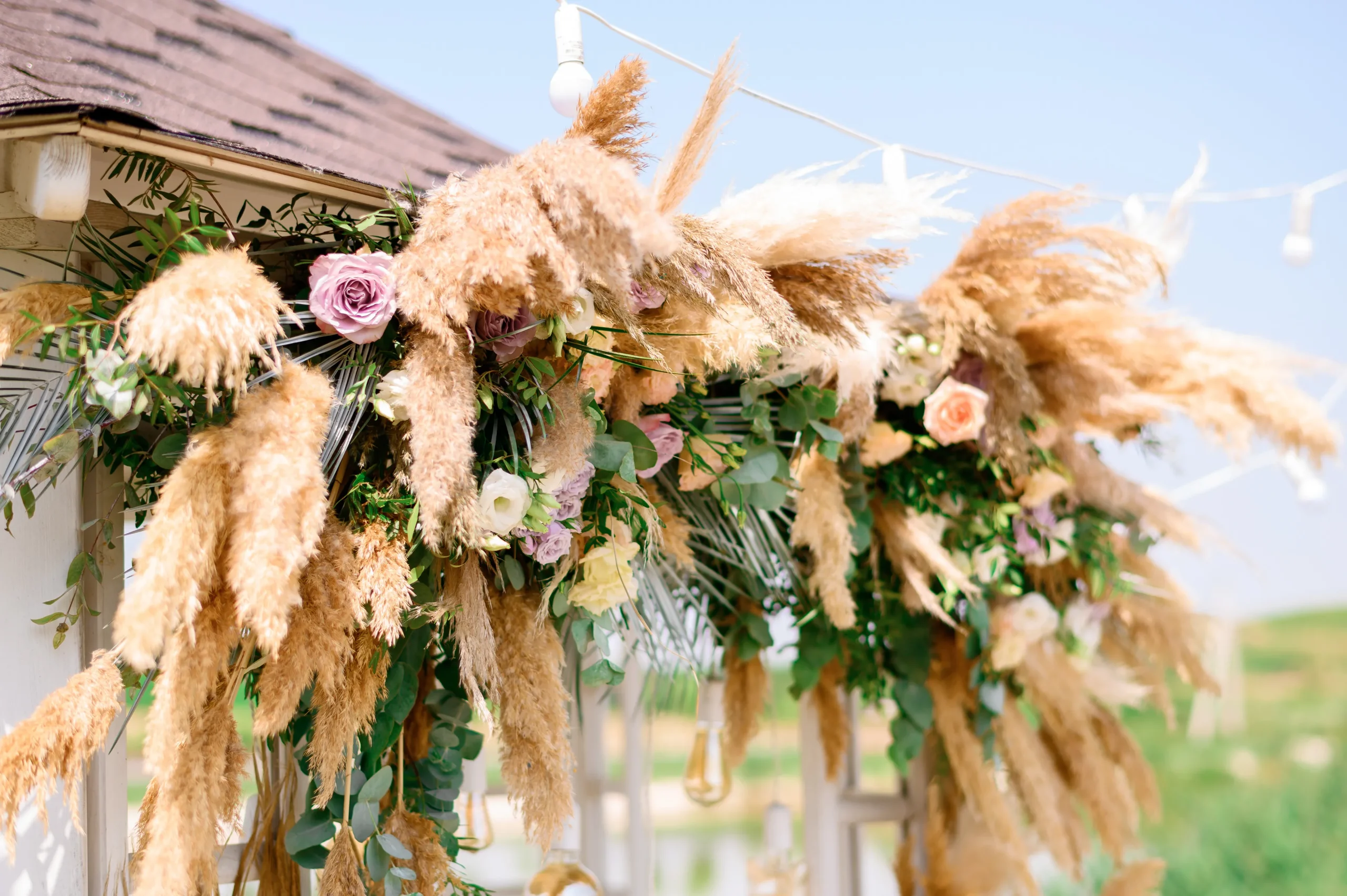 Natural outdoor wedding ceremony arch decorated with flowers